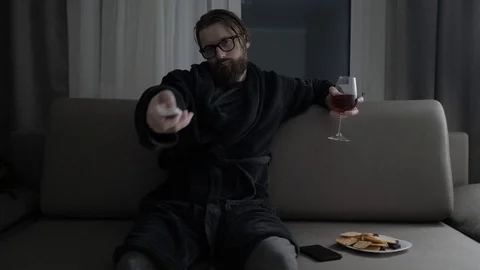 Handsome bearded man watching tv Video stock 104304537