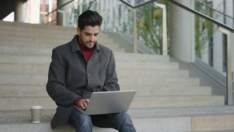 Handsome Bearded Multi Ethnic Man Sitting Outside on the Stairs, Working on Stock Footage 237605642