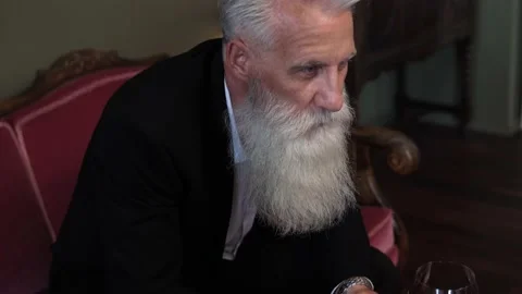 Handsome bearded senior man drinking red wine Stock-Footage 233631882