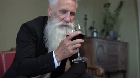 Handsome bearded senior man drinking red wine Stock Footage 233632439