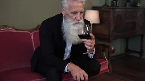 Handsome bearded senior man drinking red wine Stock Footage 233654805