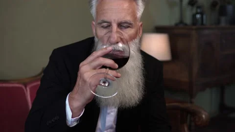 Handsome bearded senior man drinking red wine Stock Footage 233654931