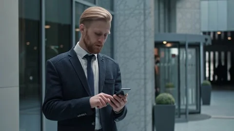 Handsome bearded Startup Businessman using mobile Phone. Young man texting Stock Footage 145332585
