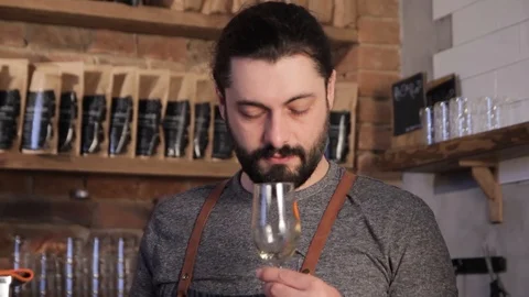 Handsome bearded winemaker tasting wine. Stock Footage 122501288