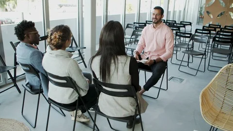 Handsome bearded worker speaking to colleagues Stock Footage 119978059