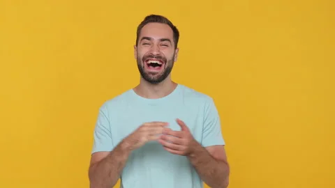 Handsome bearded young guy 20s in basic casual blue t-shirt isolated on yellow 動画素材 148282641