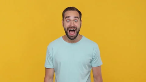Handsome bearded young guy 20s in basic casual blue t-shirt looking camera Stock Footage 148282698