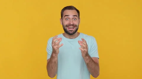 Handsome bearded young man 20s in basic casual blue t-shirt isolated on yellow 動画素材 148282738