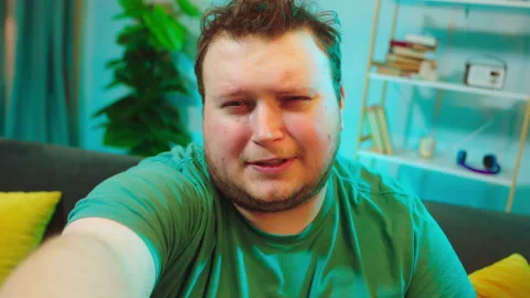 Handsome big guy take camera and start to recording a video and crying at the Stock Footage 148763533