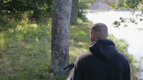 Handsome biker guy puts on his helmet and is ready to ride. Brutal country Video stock 116475994