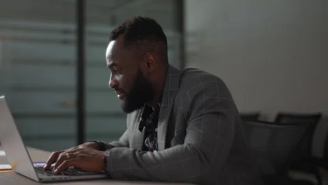 Handsome black male programmer developer coding software on laptop computer Stock Footage 248036694
