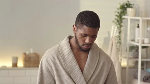 Handsome Black Man Applying Cologne on Beard after Shower Video stock 201485837
