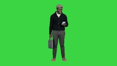 Handsome black man in a hat texting on a Green Screen, Chroma Key. Stock-Footage 147482429