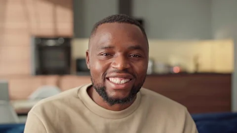 Handsome Black man looking at camera and smiling at home Stock Footage 162139628