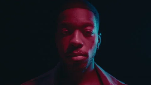 Handsome Black Man Posing in Dark Studio with Neon Lights Stock Footage 236686786
