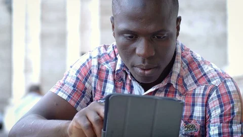 Handsome black young man using digital tablet Stock Footage 80682908