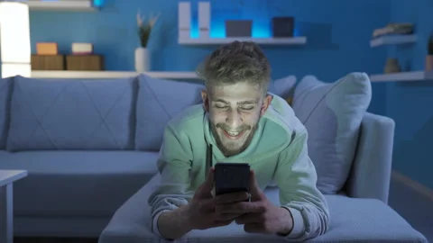 Handsome blond young man using phone is happy and pleasant. Stock Footage 234126667