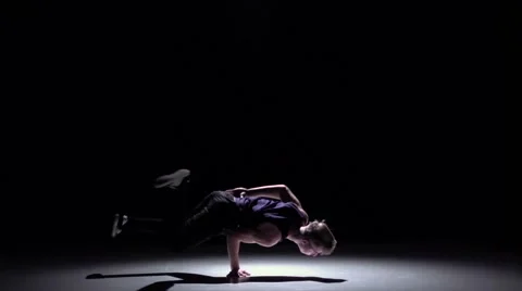 Handsome blonde breakdance style dancer continue dance, on black, shadow, slow Video stock 61178342