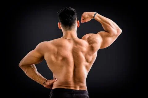 Handsome bodybuilder doing biceps pose Stock Photos
