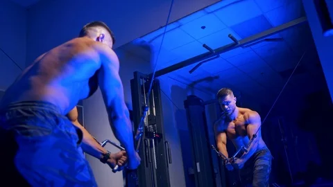 Handsome bodybuilder doing workout pushing up excercise in gym Stock Footage 119151817