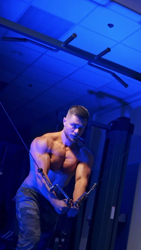 Handsome bodybuilder doing workout pushing up excercise in gym Stock Footage 296432213