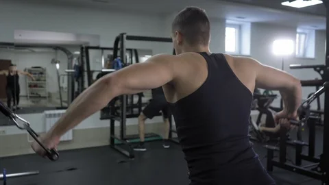 Handsome bodybuilder excercises in gym Stock Footage 102740201