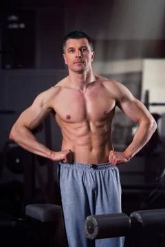 Handsome bodybuilder posing in gym, perfect muscular male body Stock Photos