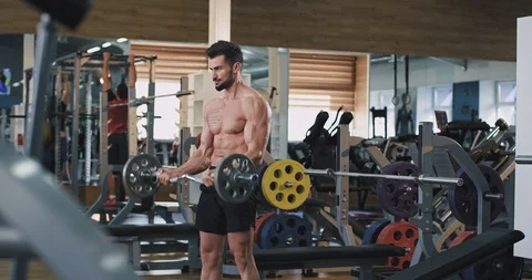 Handsome bodybuilding man working hard at gym class exercises hard to developing Video stock 114765746