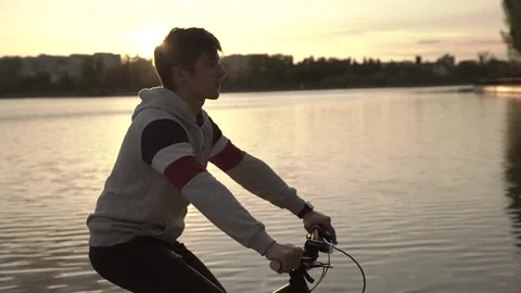Handsome boy cycling in the park Stock Footage 130473070