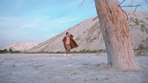 Handsome boy dance, background white mountain and blue sky Stock Footage 138865316