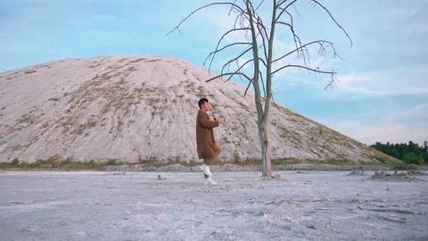 Handsome boy dance at sunset, background white mountain and blue sky Stock Footage 138865586