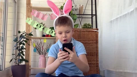 A handsome boy with Easter bunny ears on his head Stock Footage 172393612