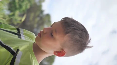Handsome boy, portrait on nature background. Video for vertical story. Stock Footage 199243192