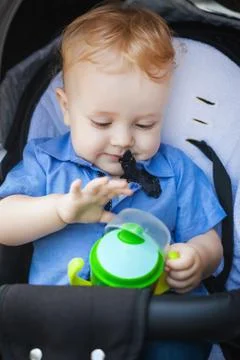 Handsome boy in pram Stock Photos