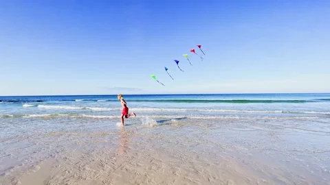 Handsome boy run on the sand beach feet in sea water Video stock 224504984