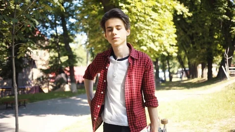 Handsome boy using a mobile phone smile keeps skate smile guy business fashion Video stock 91898331