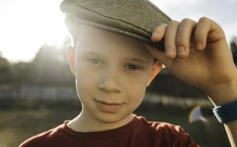 Handsome boy wearing a flat cap at sunset Stock Photos