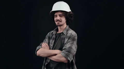 The handsome boy in the white helmet of an engineer gives a fuss from his Stock Footage 155214955