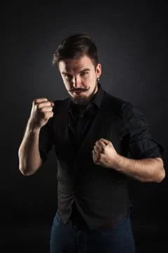 Handsome brutal guy with beard on dark background Foto stock