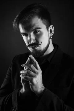 Handsome brutal guy with beard on dark background Stock-Fotos
