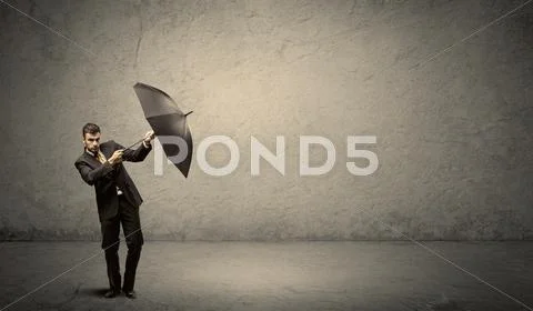 Handsome business man holding umbrella with copy space background Stock Photos