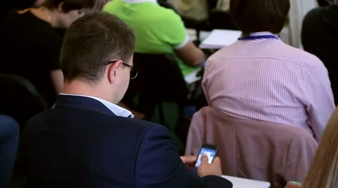 Handsome business man using smartphone on business training seminar Stock Footage 64998461