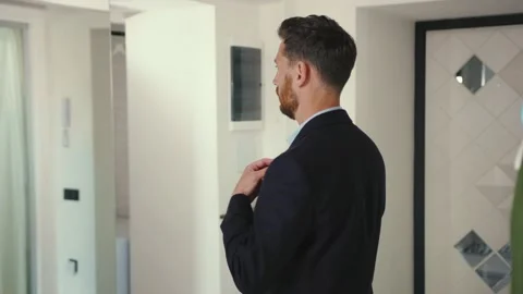 Handsome businessman getting ready with mask look at mirror and wearing suit Stock Footage 132540554