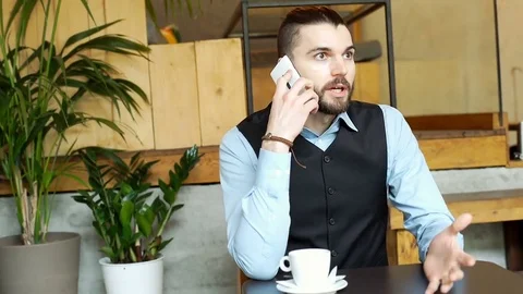Handsome businessman having an argument while talking on cellphone, steadycam  Stock-Footage 73305596