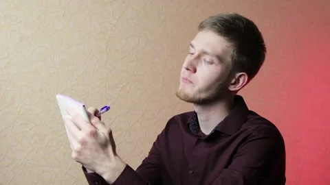 Handsome businessman puts some notes in his notepad. Business, having a deal Stock Footage 146740738