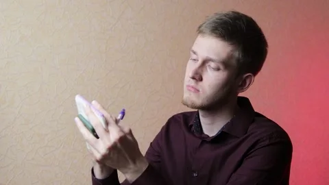 Handsome businessman puts some notes in his notepad. Using smartphone to find Stock Footage 146740828