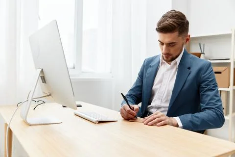 Handsome businessman sitting at the computer work boss workplace Stock Photos
