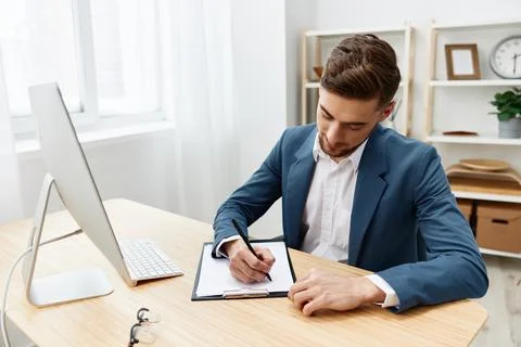 Handsome businessman sitting at the computer work boss documentation Gray Stock Photos