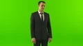 The handsome businessman stand on the green background 4k or 4k+ Resolution