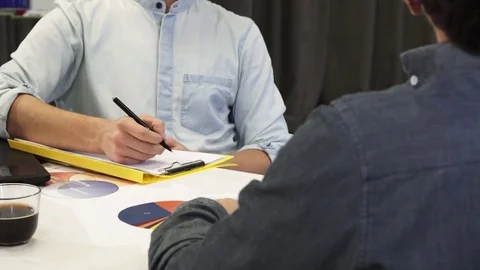 Handsome businessman taking notes during business meeting Stock Footage 85105763